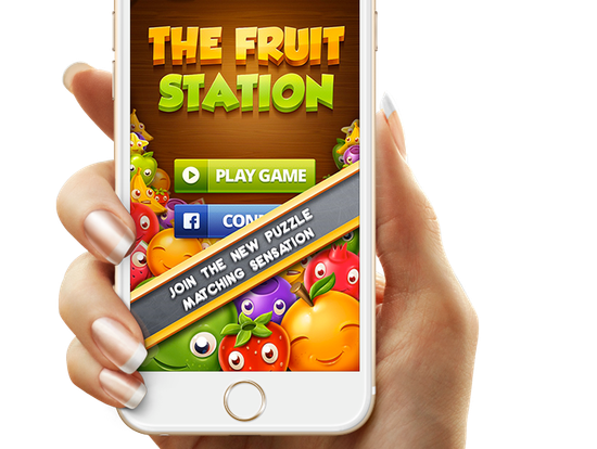 A person is holding a cell phone that says the fruit station