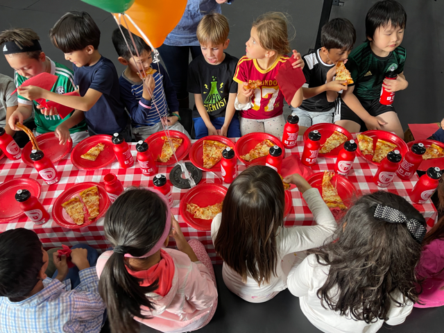Kids cutting a cake together