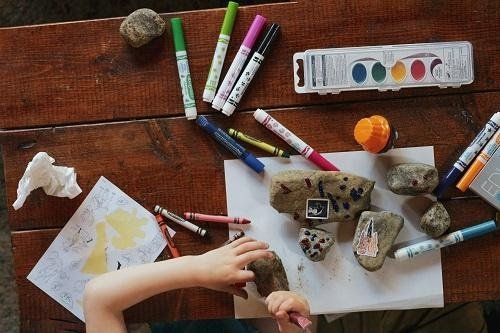 A kid coloring with markers