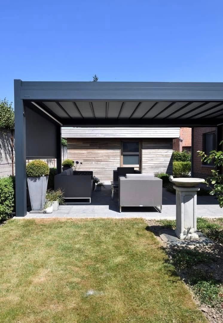 A Patio With A Table And Chairs Under A Pergola — Night & Day Blinds and Awnings in Pakenham, VIC