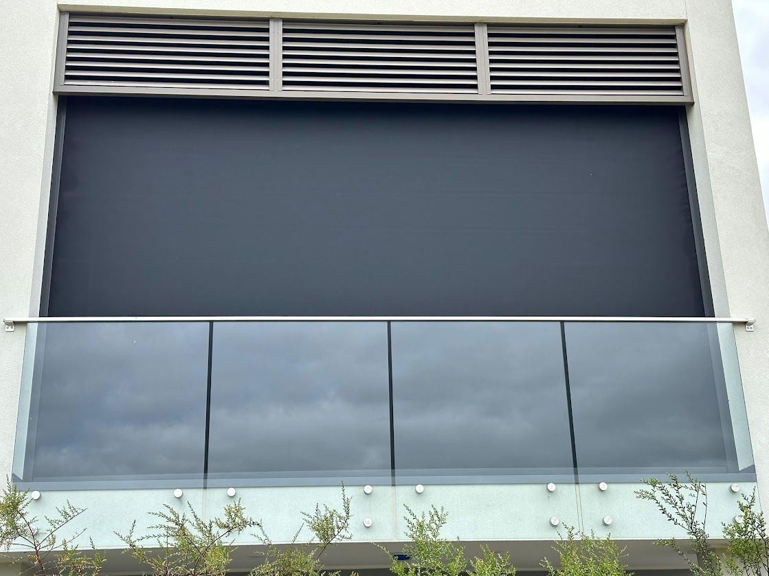 A Deck With Black Roller Blinds — Night & Day Blinds and Awnings in Pakenham, VIC