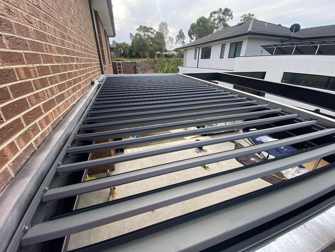 A House With A Covered Patio And A Potted Plant In Front Of It — Night & Day Blinds and Awnings in Pakenham, VIC