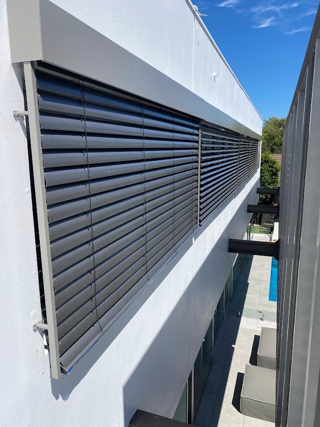 A White House with Grey PVC Blinds on the outside — Night & Day Blinds and Awnings in Pakenham, VIC
