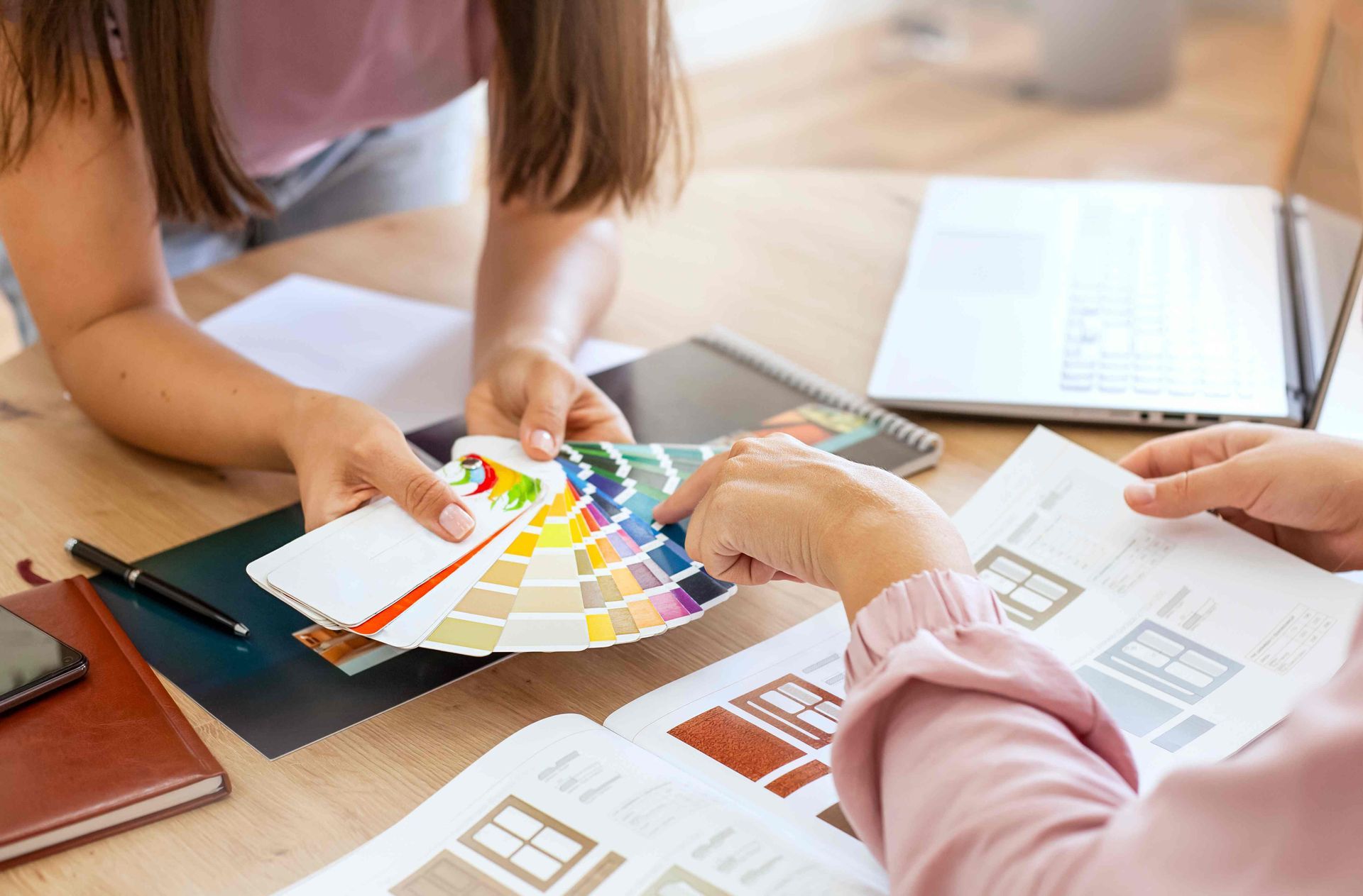 A window treatment specialist and client choosing materials at a window treatment consultation near Lutherville, Maryland (MD)