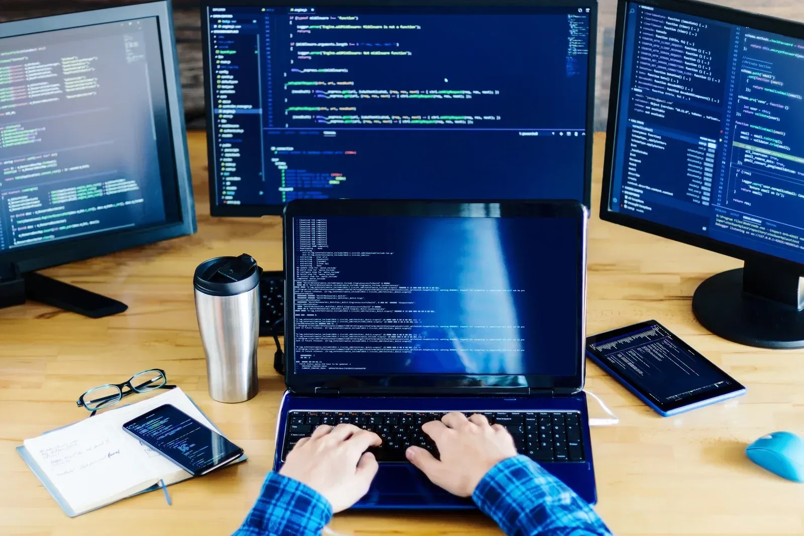 Business professional points at analytics dashboard on desktop monitor in a bright office.