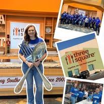 Woman holding a trophy in front of a Three Square food bank display, with event photos around her