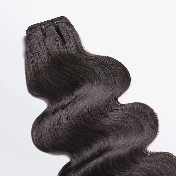 A close up of a piece of hair on a white surface.