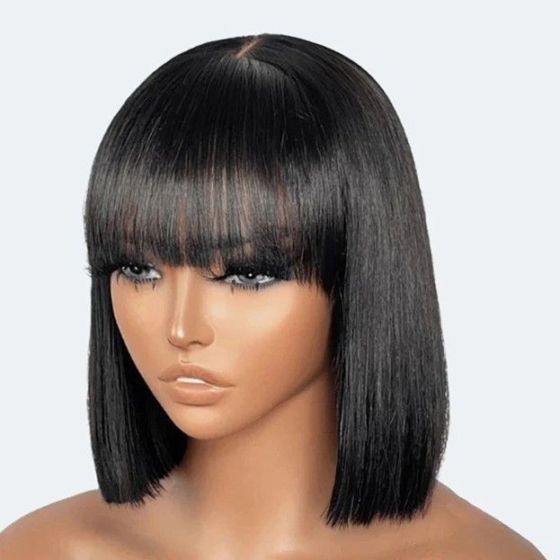 A woman is wearing a black wig with bangs.