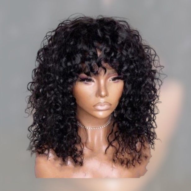 A mannequin is wearing a curly wig with bangs.
