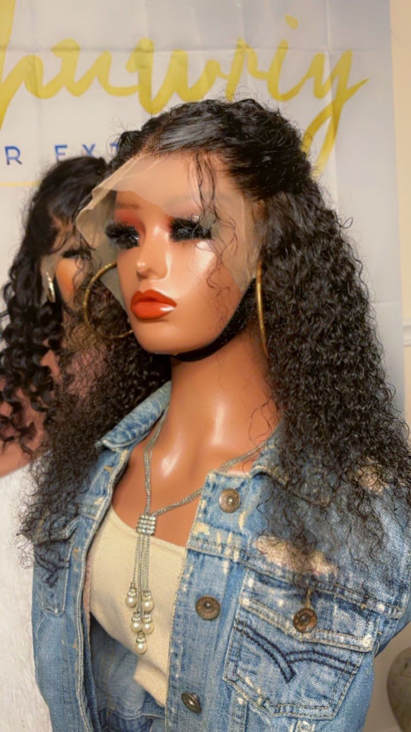 A mannequin wearing a denim jacket and a lace front wig.