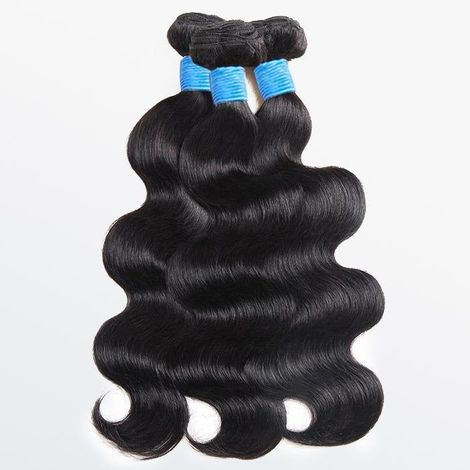 Three bundles of hair are stacked on top of each other on a white surface