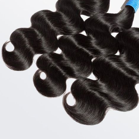 A close up of a bundle of hair on a white surface.