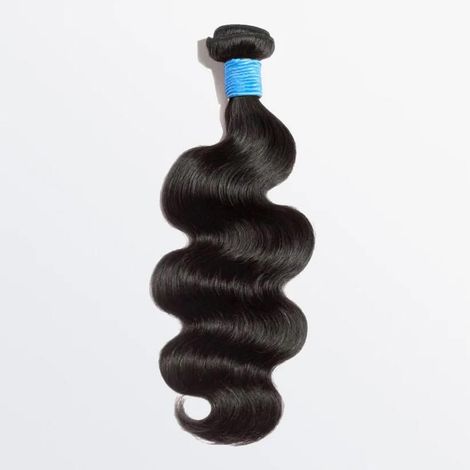 A close up of a bundle of hair on a white surface.