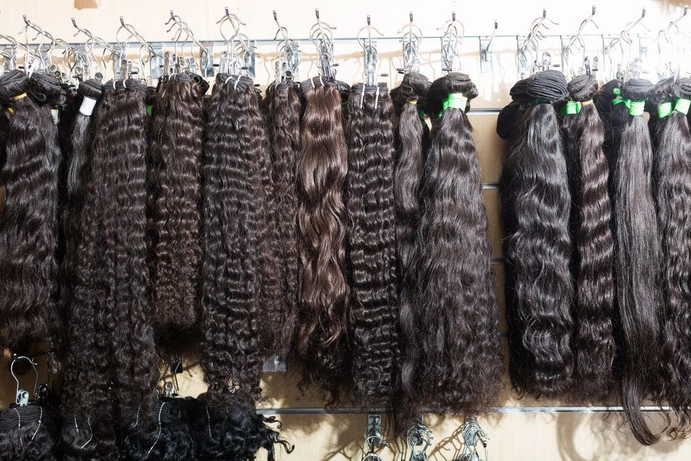 A bunch of hair extensions hanging on a rack