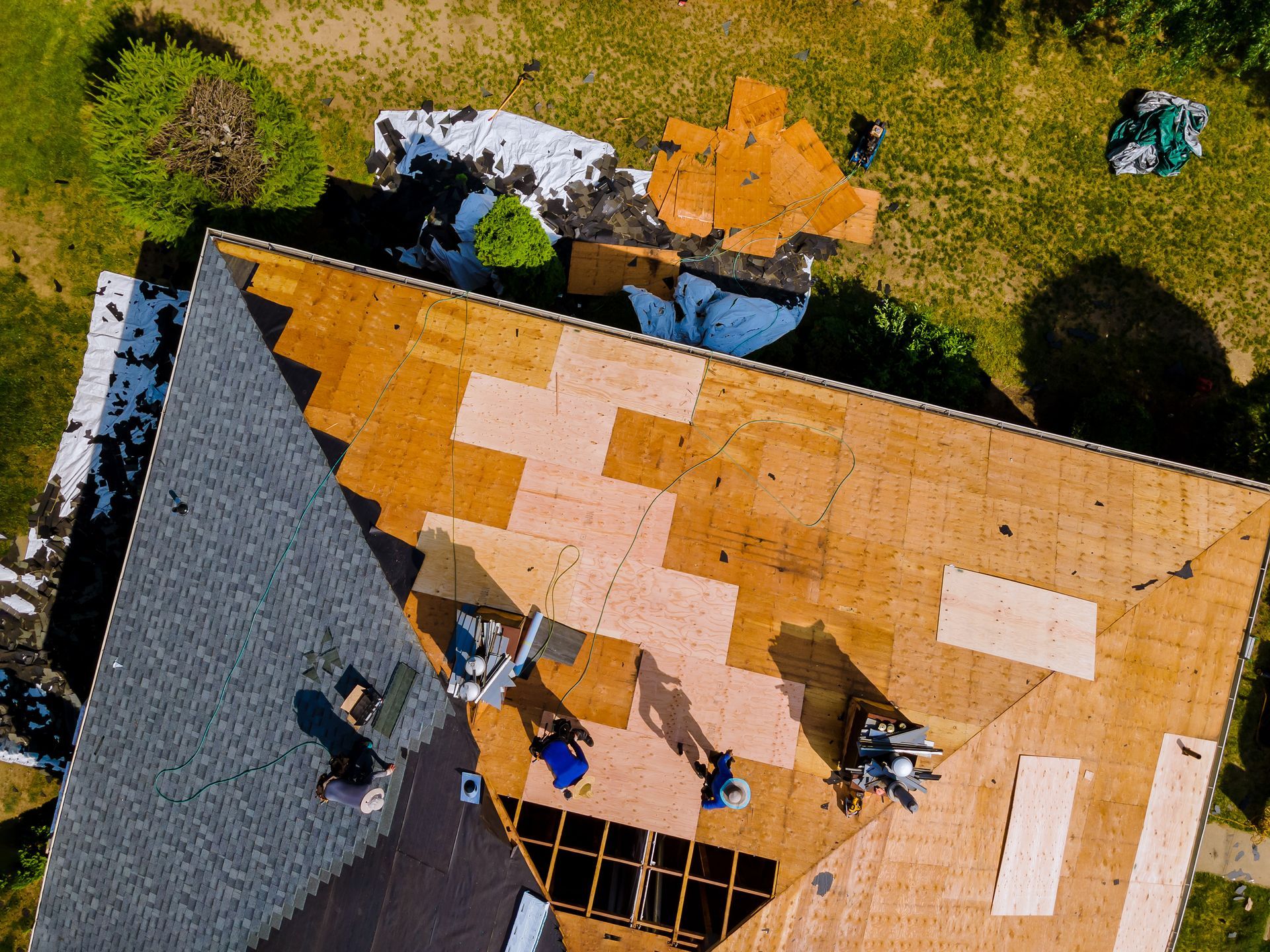 Roof construction repairman on a residential apartment with new roof shingle being applied. Roof construction repairman on a residential apartment with new roof shingle being applied.