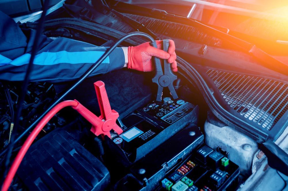 A Person Is Charging A Car Battery With A Jump Starter — Edmonton Car Air in Cairns, QLD