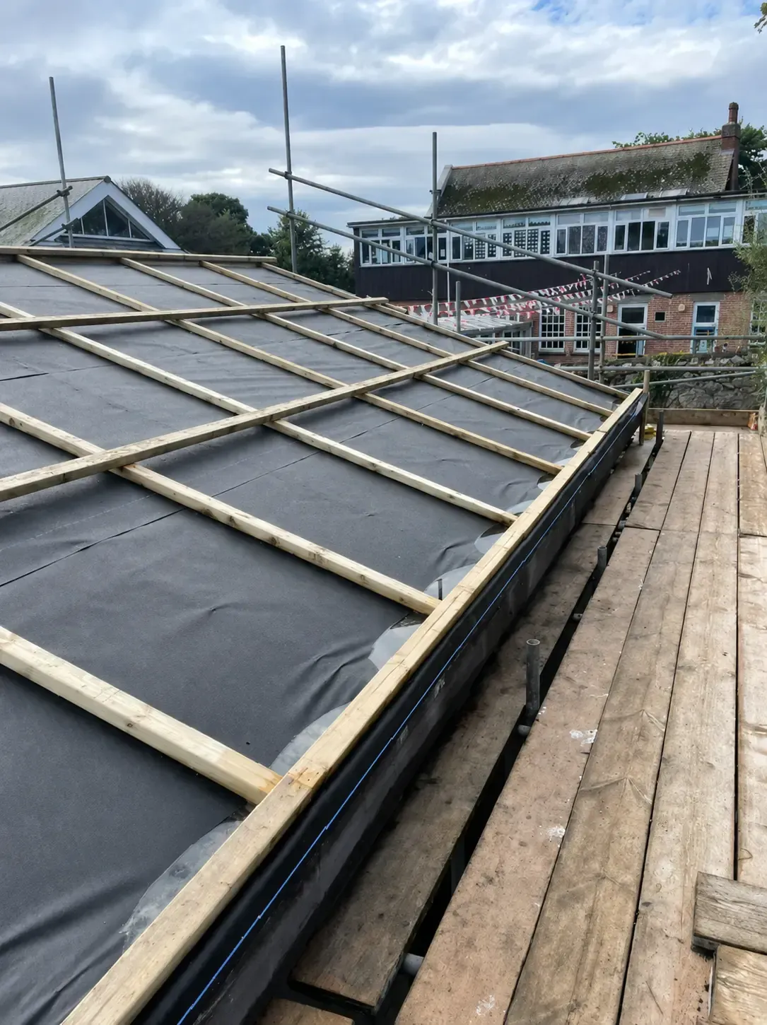 Roof membrane and timber battens prepared for a metal roofing installation