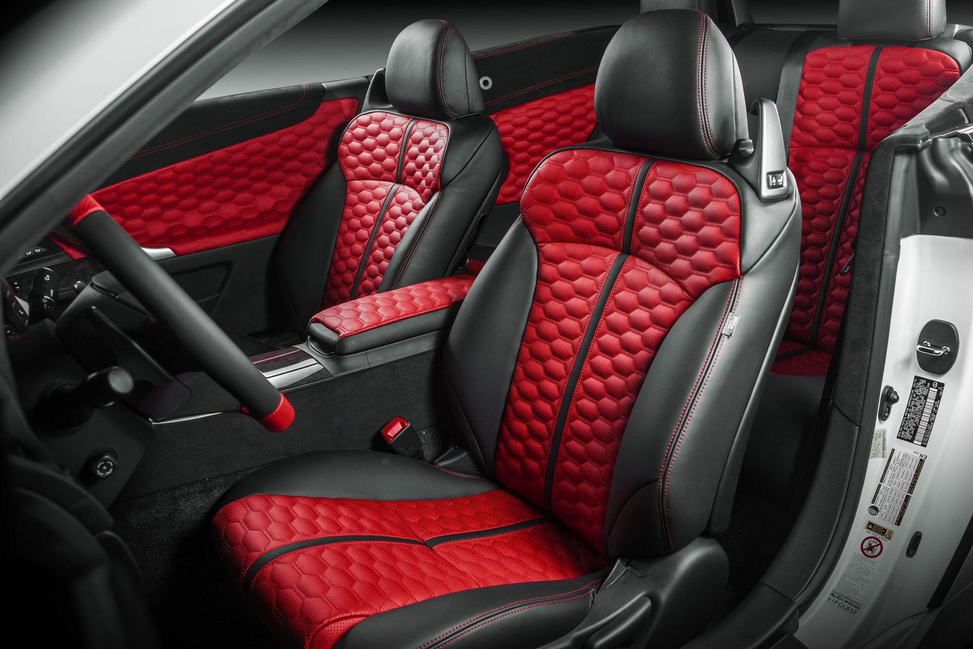 Red and black quilted car seats and door panels in a sporty interior