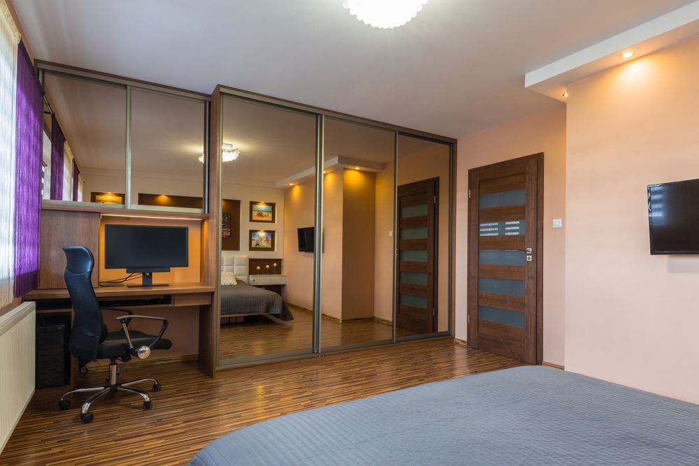 A Bedroom With a Bed , Desk , Chair and Television — Ideal Glass In Winnellie, NT