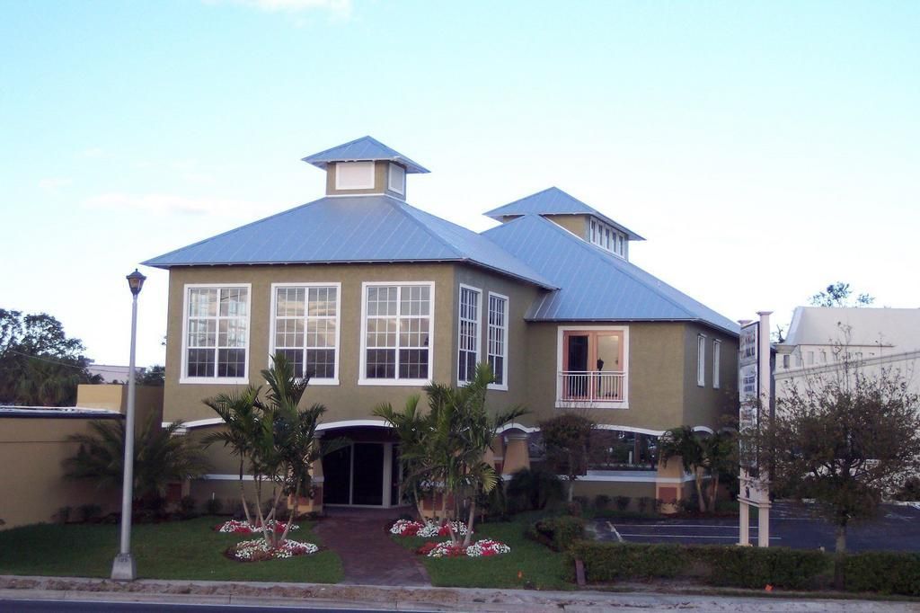 A large green house with a blue roof