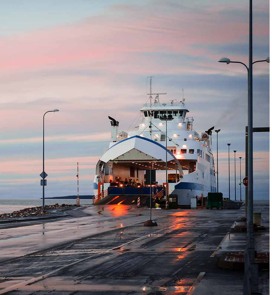 A large white and blue ship is docked at a dock