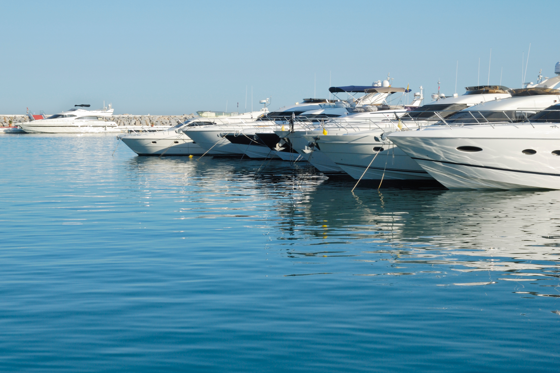A large blue boat is floating on top of a large body of water