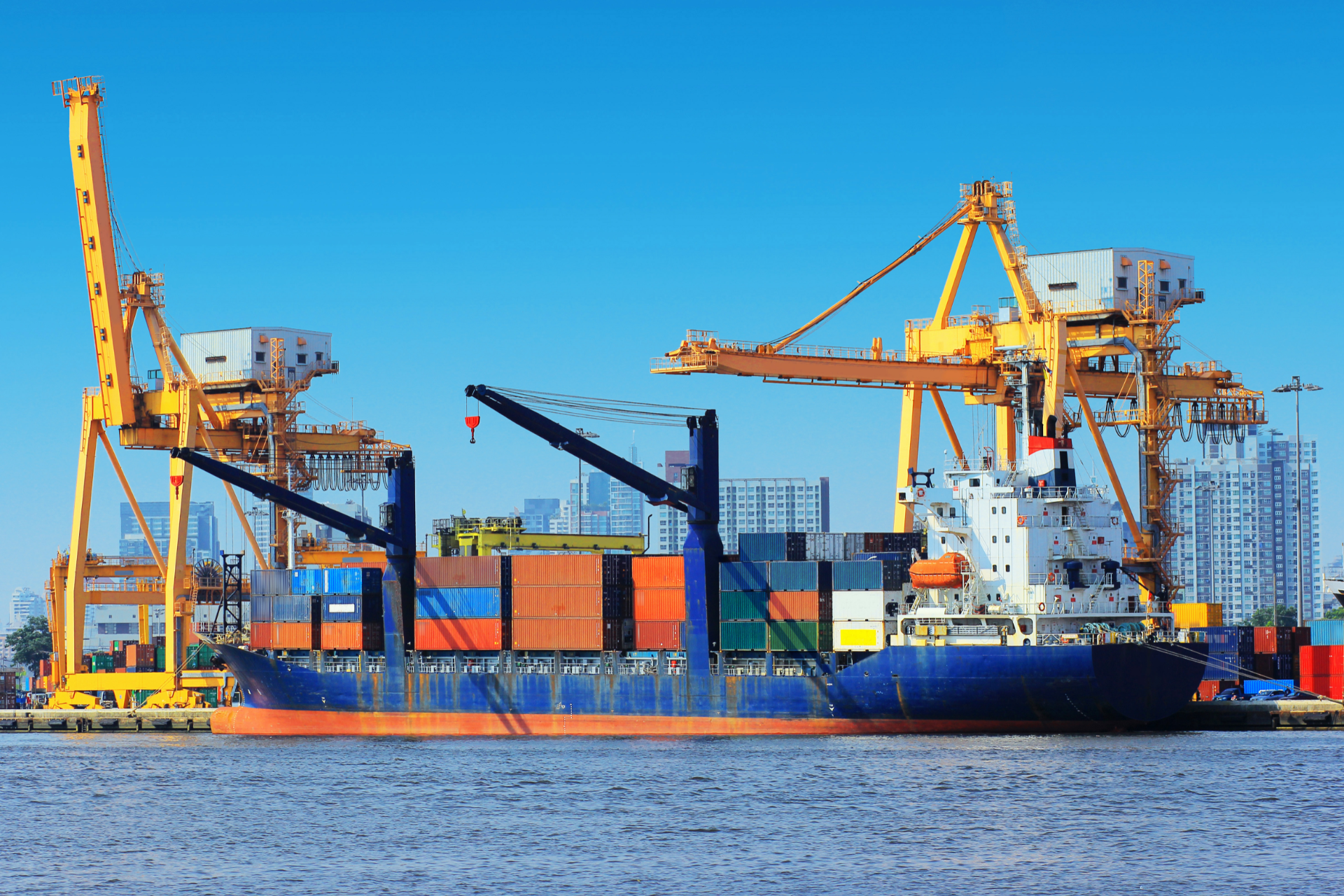 A large blue boat is floating on top of a large body of water
