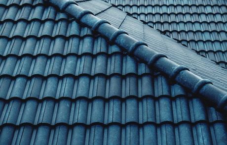 A close up of a blue tiled roof