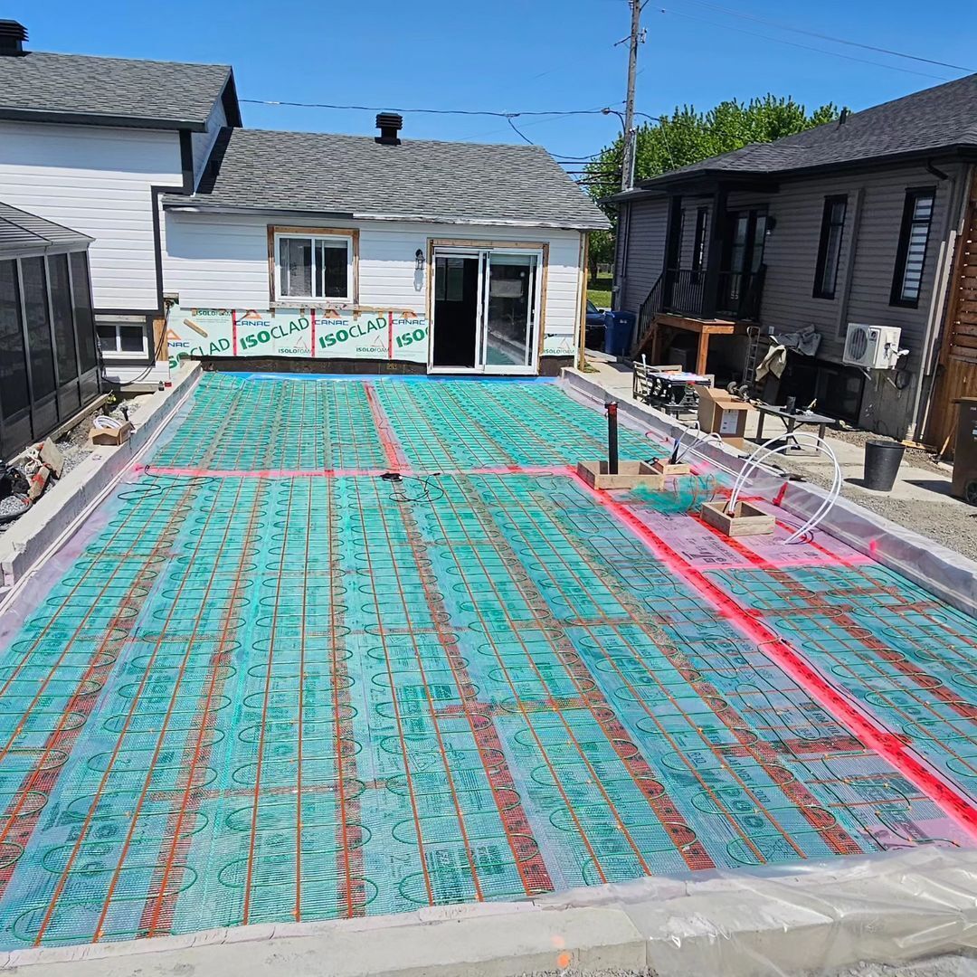 A swimming pool is being built in the backyard of a house.
