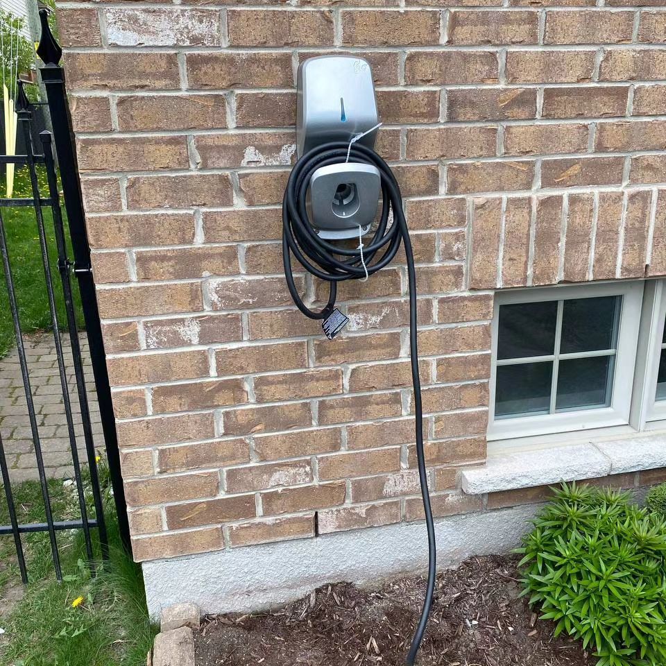 A brick wall with a charger attached to it