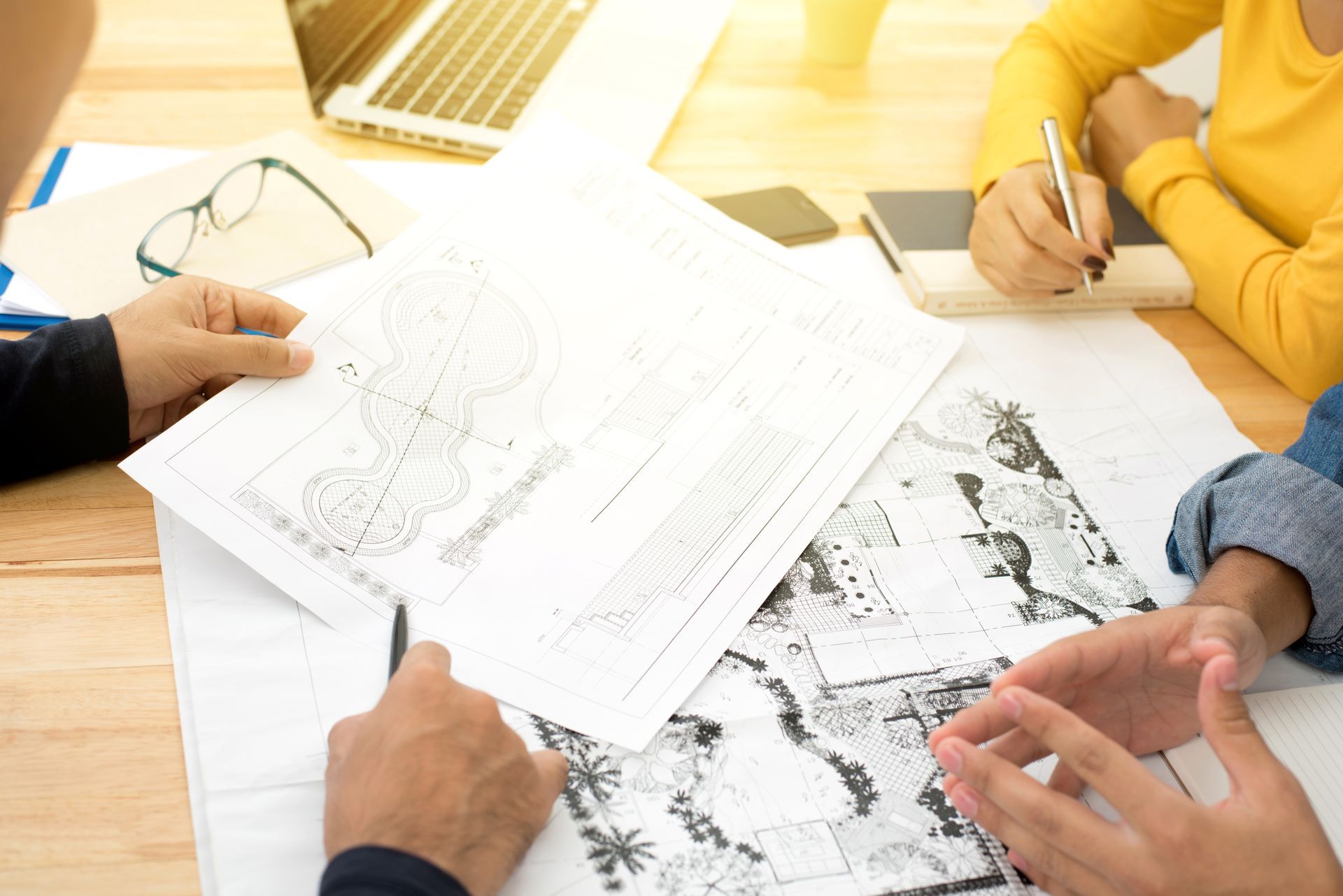 A team is discussing landscape blueprints. A team is discussing landscape blueprints.