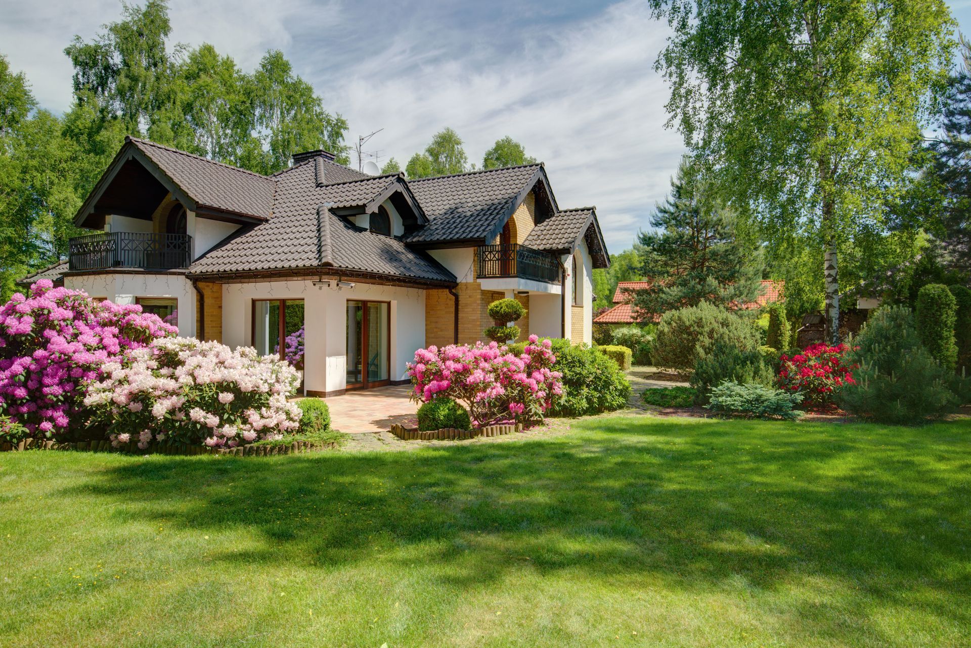 Vibrant garden with flowers and shrubs by Philip Moser Associates, Inc., top landscape design 