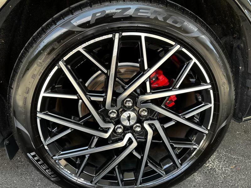 A close up of a car wheel with a tire on it