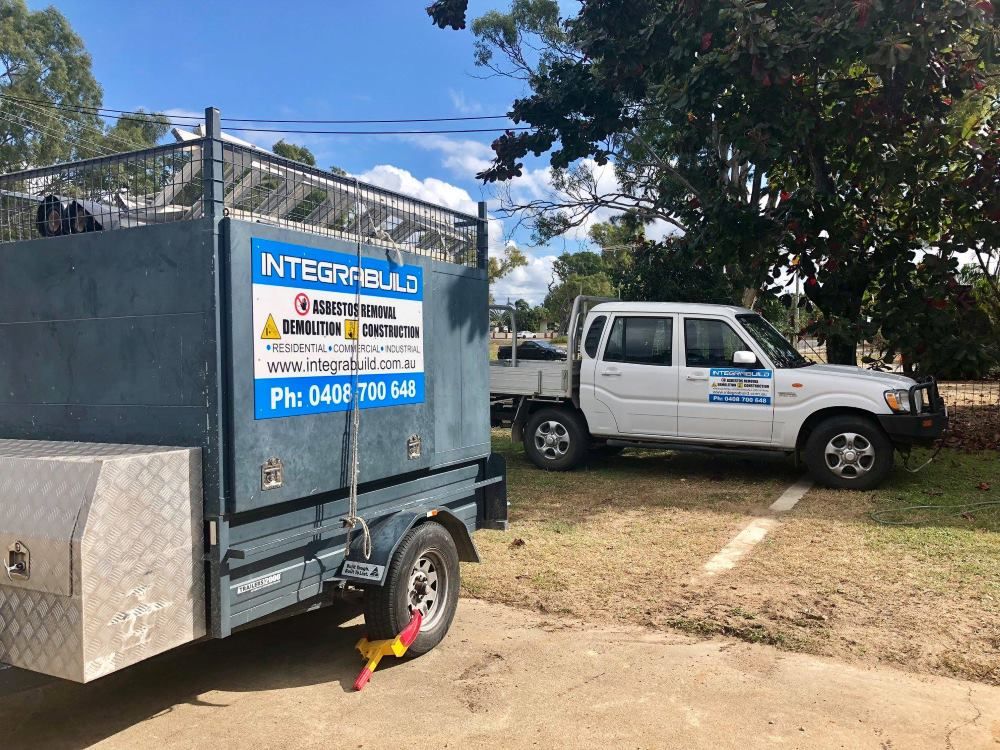 A Truck And Trailer Are Parked Next To Each Other On A Dirt Road — Integrabuild in Bowen, QLD