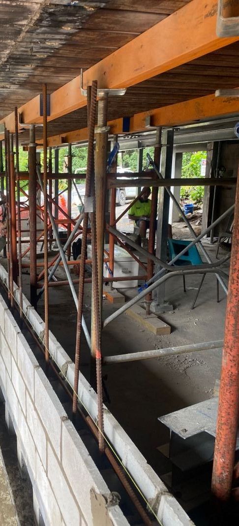 A Group Of Construction Workers Are Working On A Wall — Integrabuild in Airlie Beach, QLD