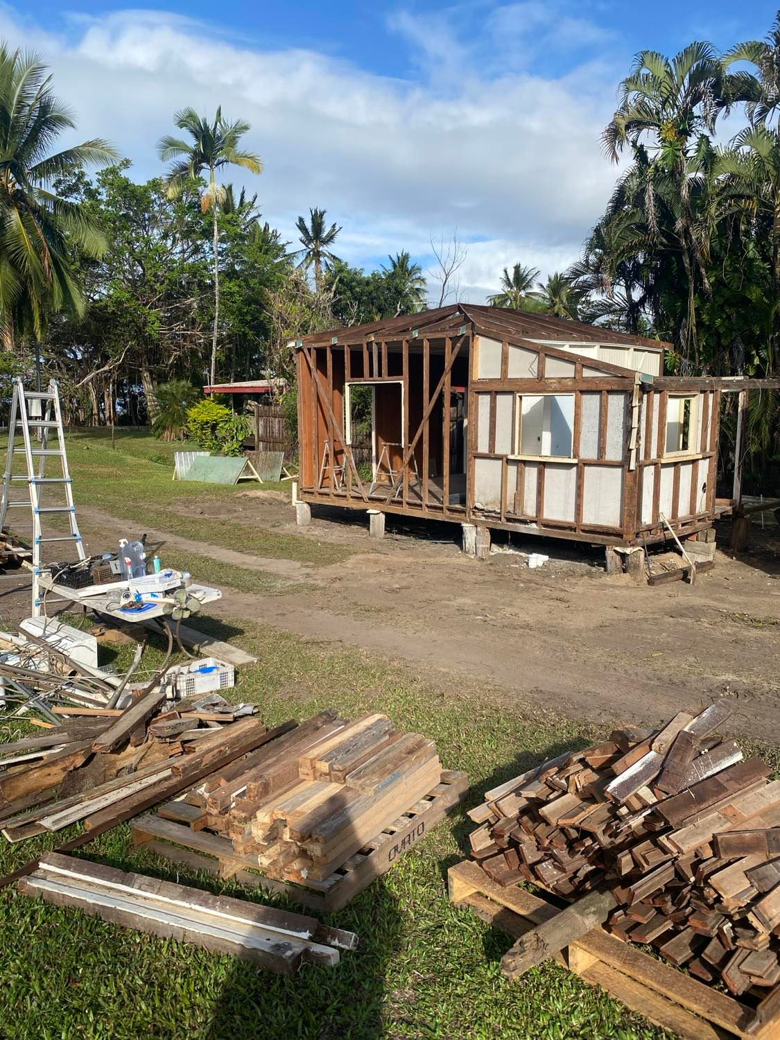 Grassy Yard Near Piles of Debris and a Step Ladder — Integrabuild in Bowen, QLD