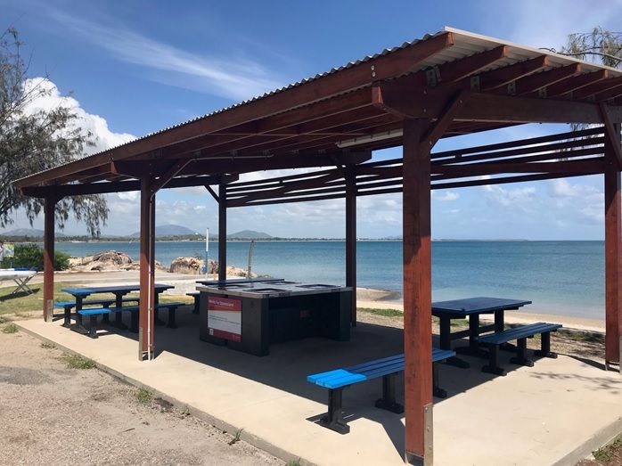 A Covered Area With Tables And Benches Overlooking The Ocean — Integrabuild in Bowen, QLD