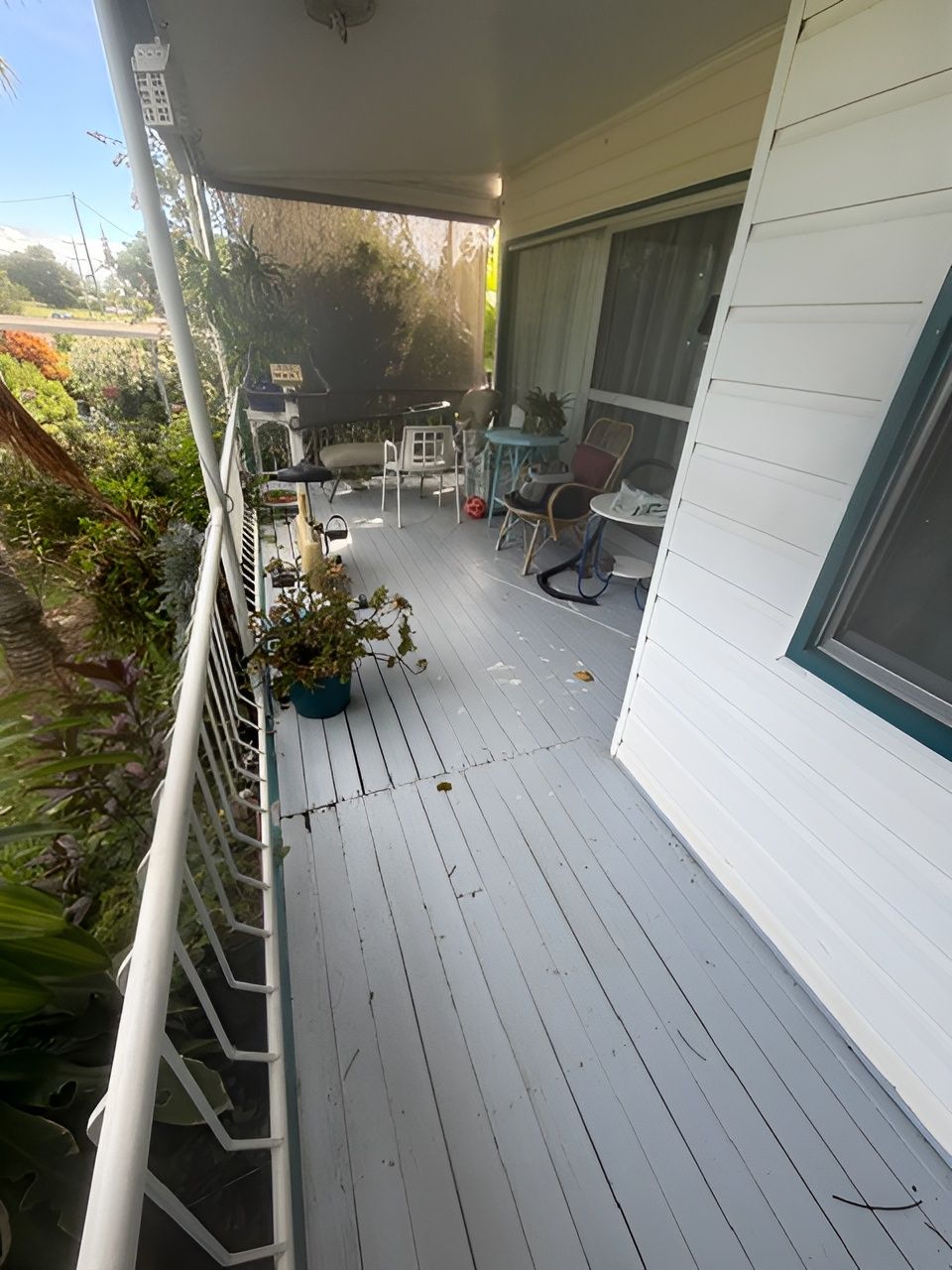 Covered Front Porch with Gray Floor, and Railing Overlooking a Garden — Integrabuild in Bowen, QLD