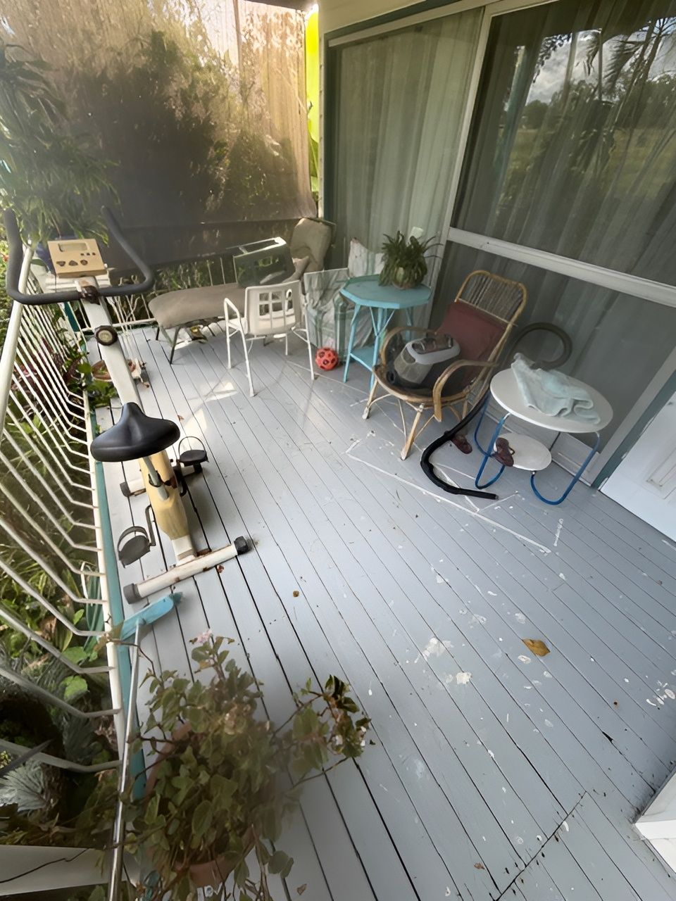 Small Outdoor Balcony with White Deck and Potted Plants Along the Railing — Integrabuild in Bowen, QLD