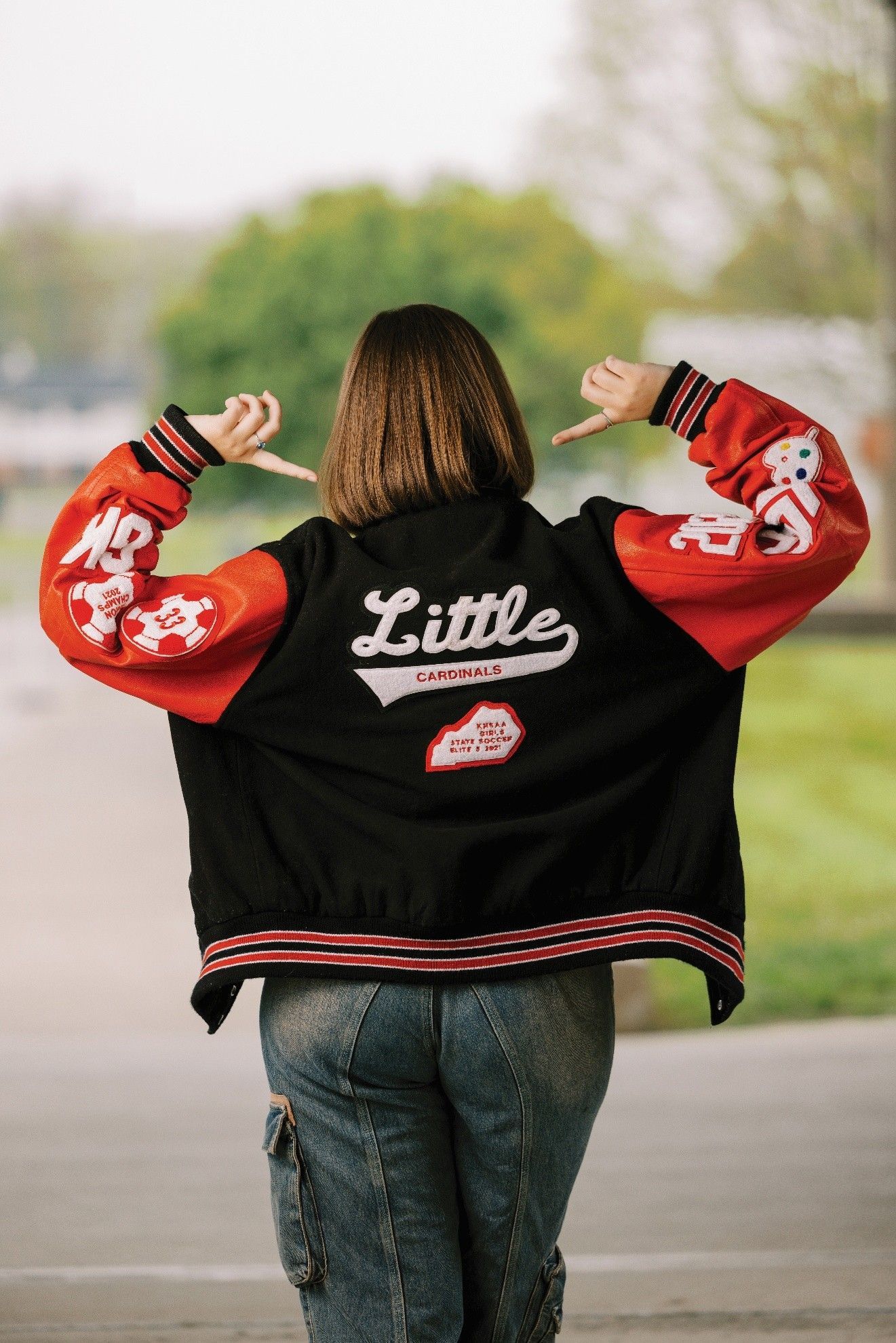 Person wearing a black and red jacket with