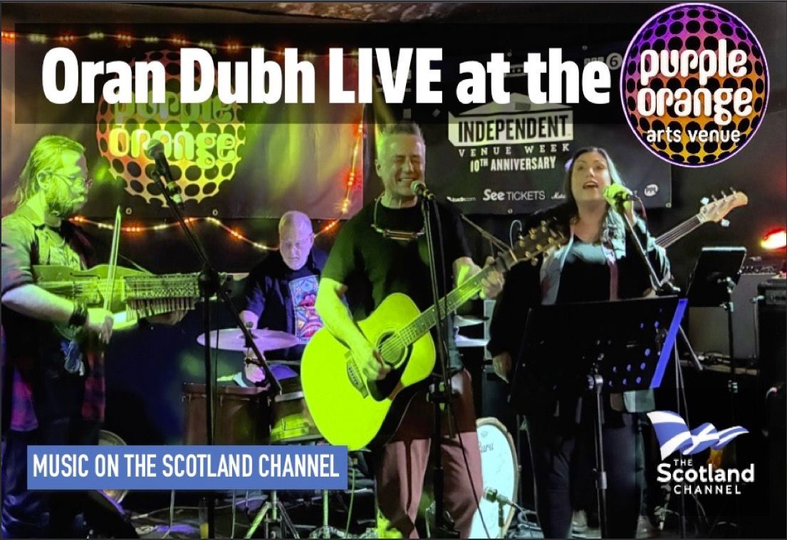 Oran Dubh Live at The Purple Orange Join us as acoustic folk-rock band Oran Dubh perform live at Bathgate’s Purple Orange Arts Venue. Oran Dubh features the vocal talents of Claire Gibson and John Strachan, the emphasis is very much on the songs which are uplifting and poignant; being about peace, love and hope.
The line up has vocals, drums, bass, acoustic guitar and a combination of mandolin/banjo/whistle being played by multi-instrumentalist Hugh Stewart.
Hailing from Glasgow and the West Coast of Scotland, Oran Dubh perform memorable, uplifting and original songs.