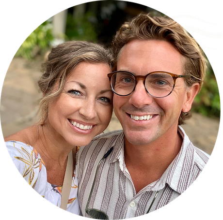 Smiling couple posing closely outdoors in soft natural light