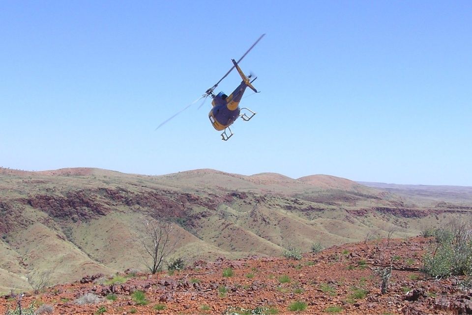 yellow and blue color helicopter flying