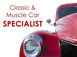 Classic and muscle car specialist with a red vintage car close-up Classic and muscle car specialist with a red vintage car close-up