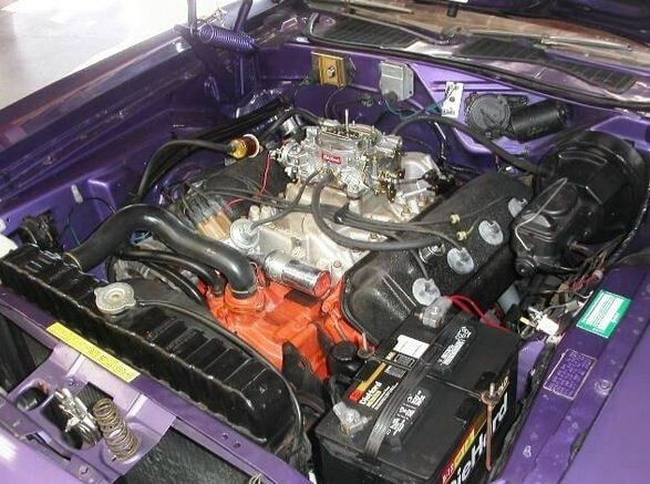 Purple car engine bay with a chrome engine and black components under the hood