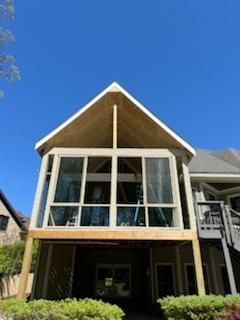 Screened porch addition on a house, under construction with a gabled roof.