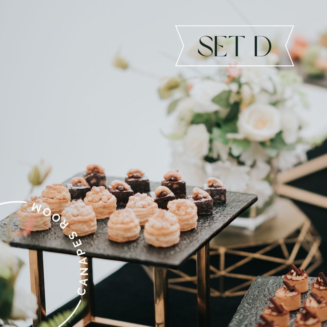 Canapés on a black serving tray with a gold frame, labeled