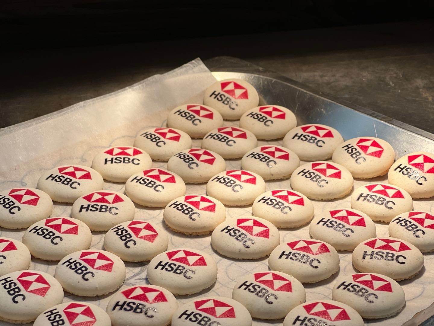 Tray of baked cookies with the HSBC logo printed on top.