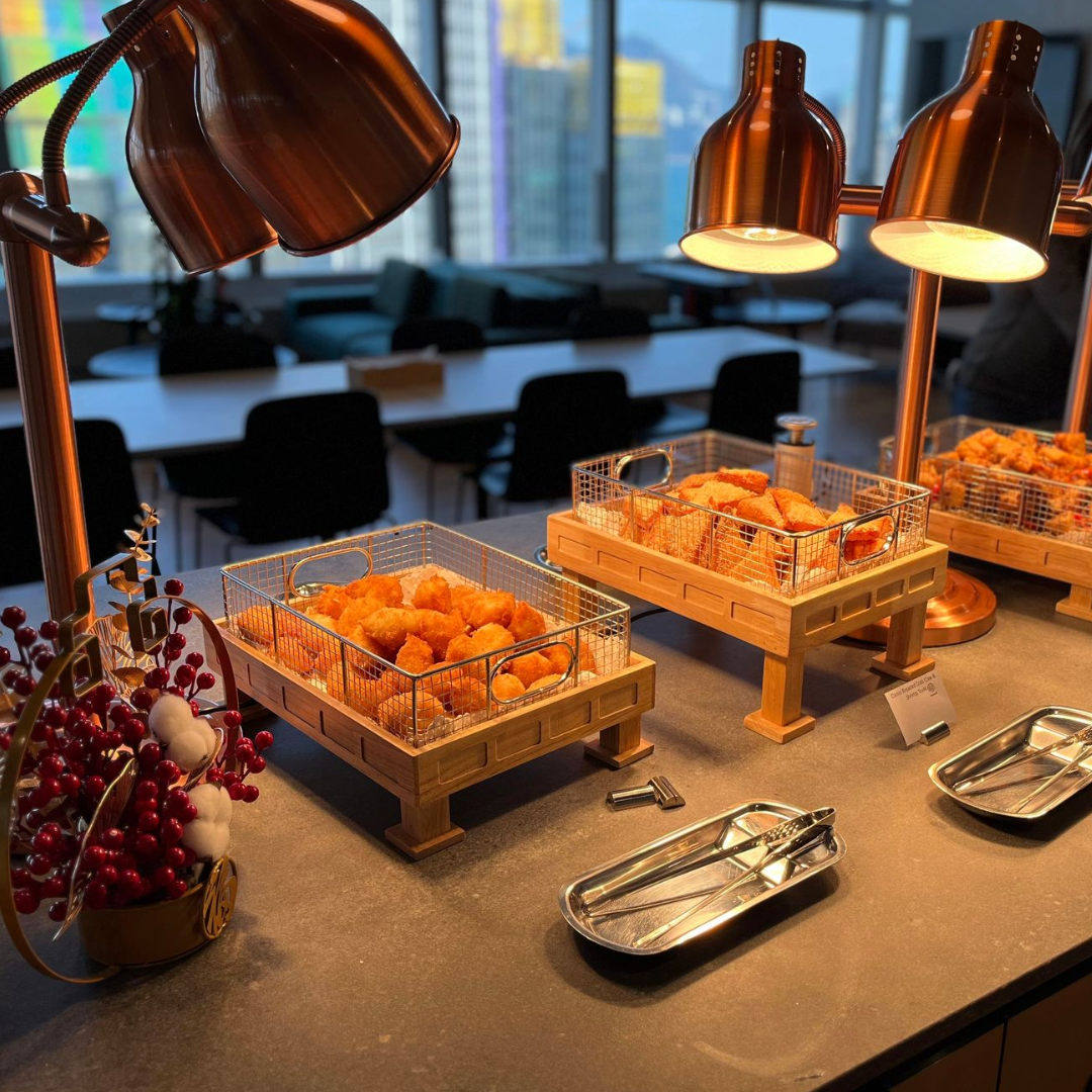 Display of pastries: Red and green eclairs with sprinkles, plus salmon appetizers on a tiered serving tray.