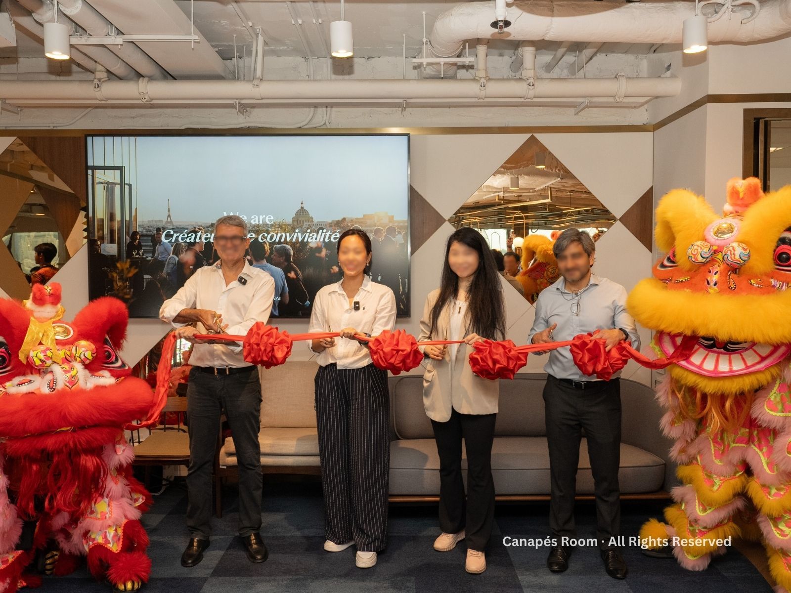 People cutting a red ribbon with a Chinese lion dance, opening event.